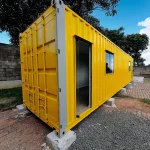 Shipping container set level on concrete block foundation pads on a gravel site